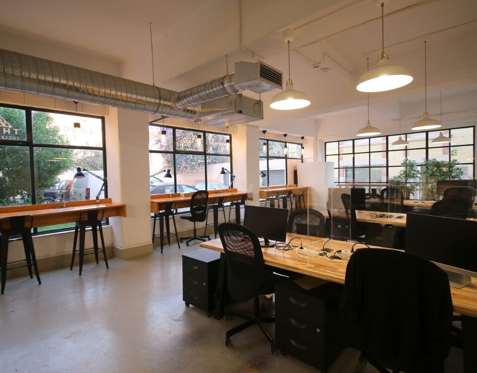 An amazing picture of Virtual Office's space at day show the beautiful day outside of the office though the big glass window